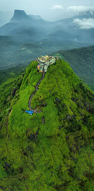 Pilgrims climbing Adam’s Peak (Sri Pada) before sunrise, a sacred mountain in Sri Lanka known for its panoramic summit views.