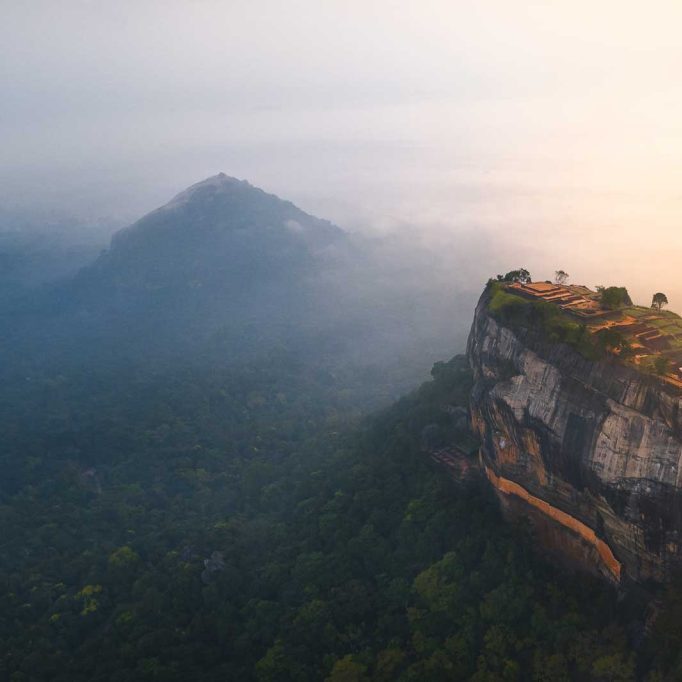 Aerial view of Sigiriya Rock Fortress, an ancient UNESCO World Heritage site in Sri Lanka at sunrise.