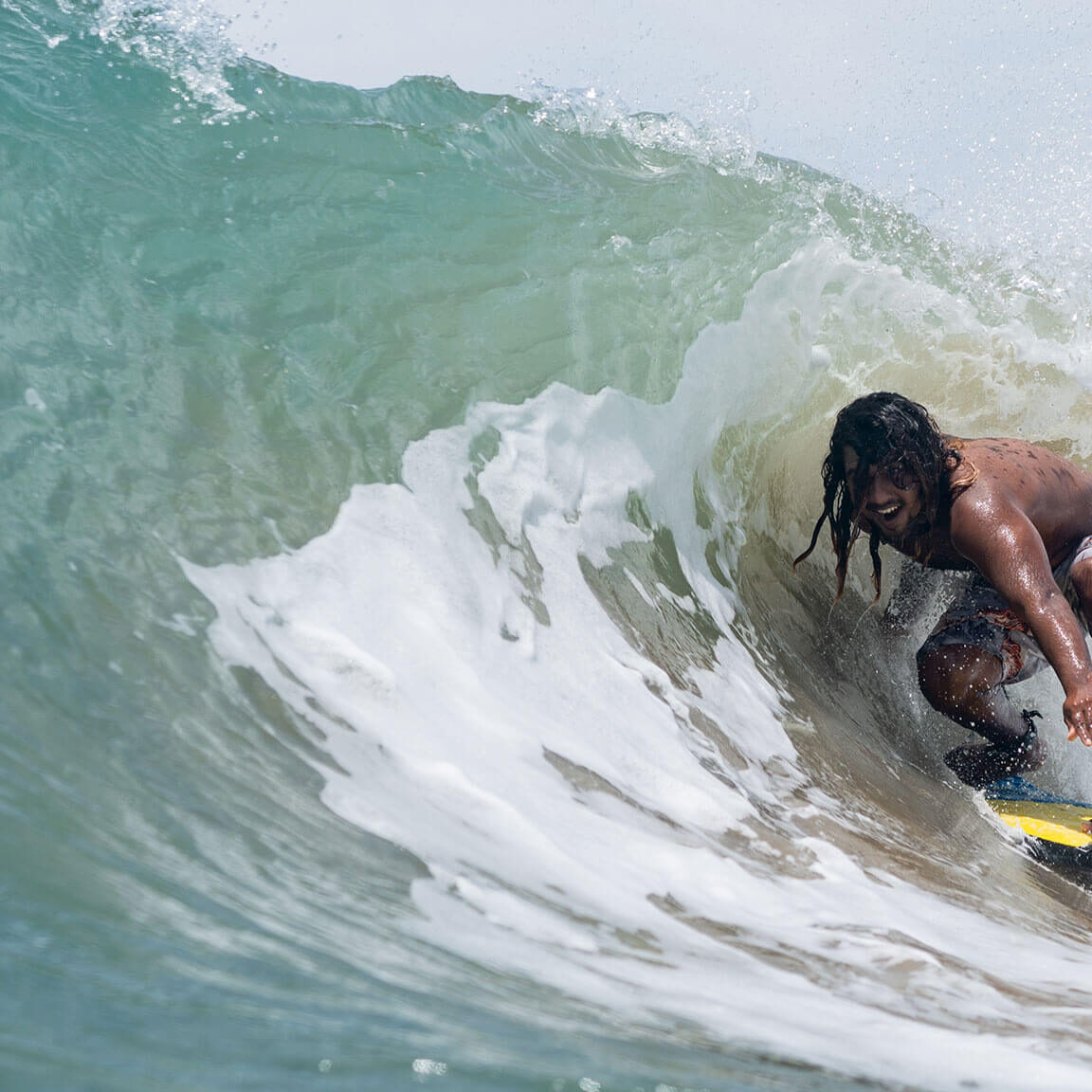 Surfer catching a wave at Arugam Bay, one of Sri Lanka’s top surf spots.